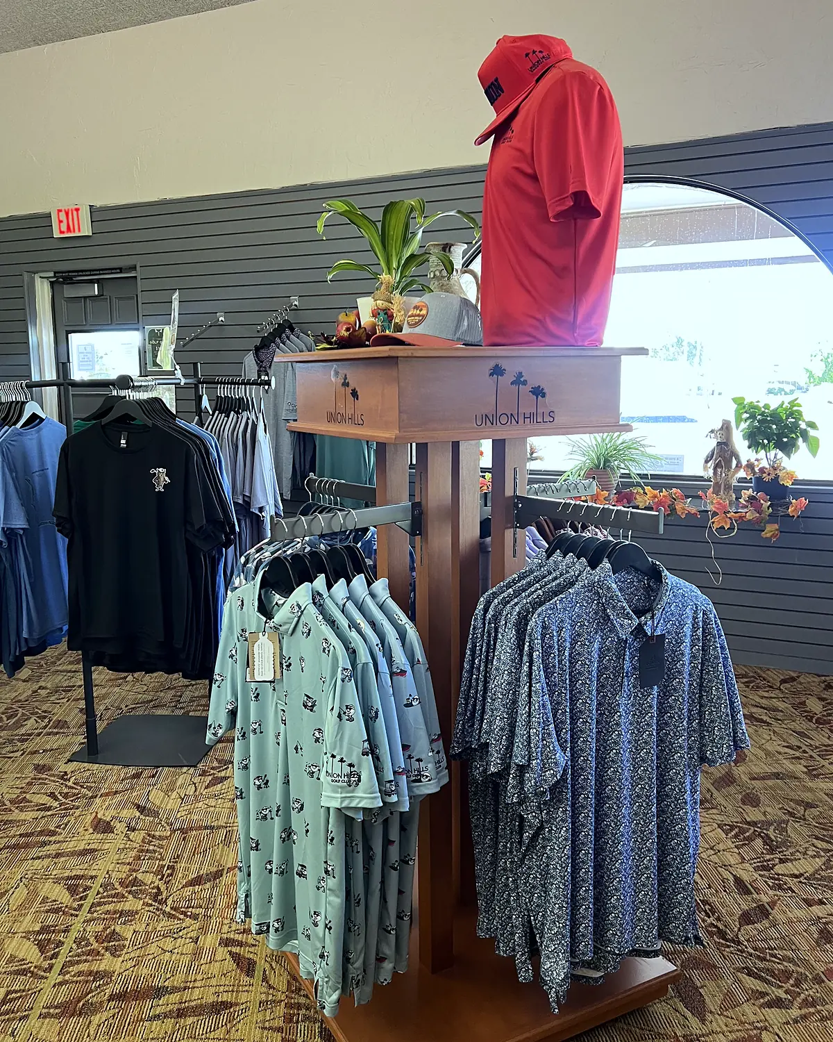 Men's golf polos on a Union Hills display rack